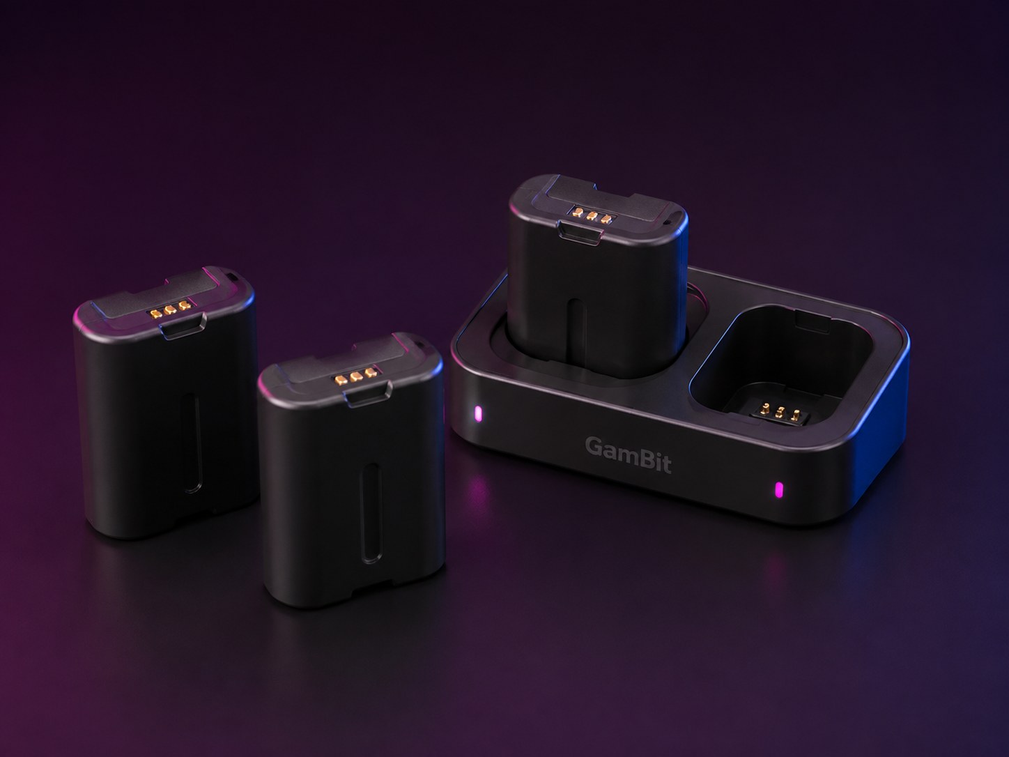 Concept visualization: Compact spare battery cartridges beside a desktop charging dock